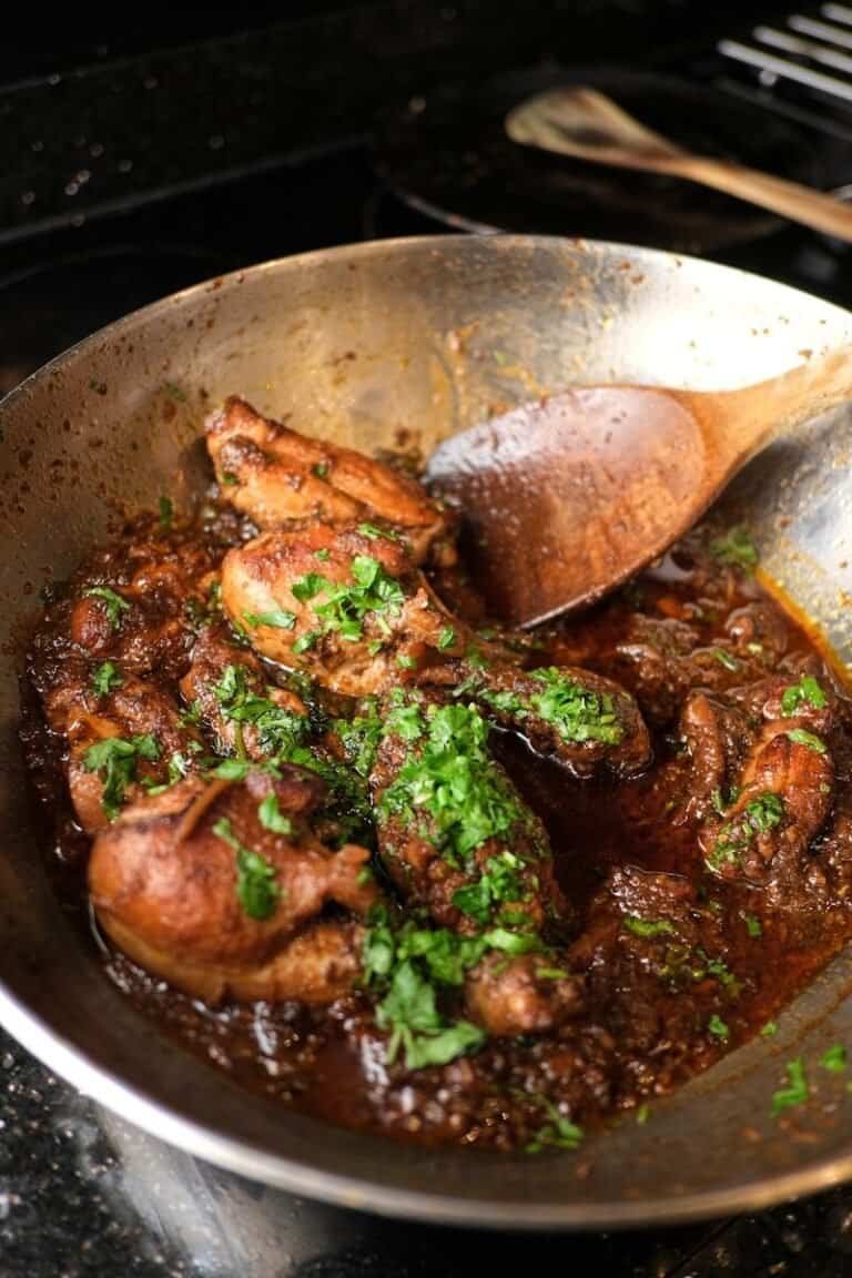 Easy Chicken recipes a pan filled with meat and vegetables on top of a stove
